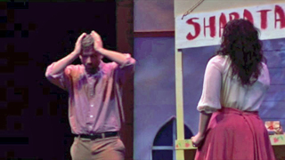 Frank holds his head while Marie looks on